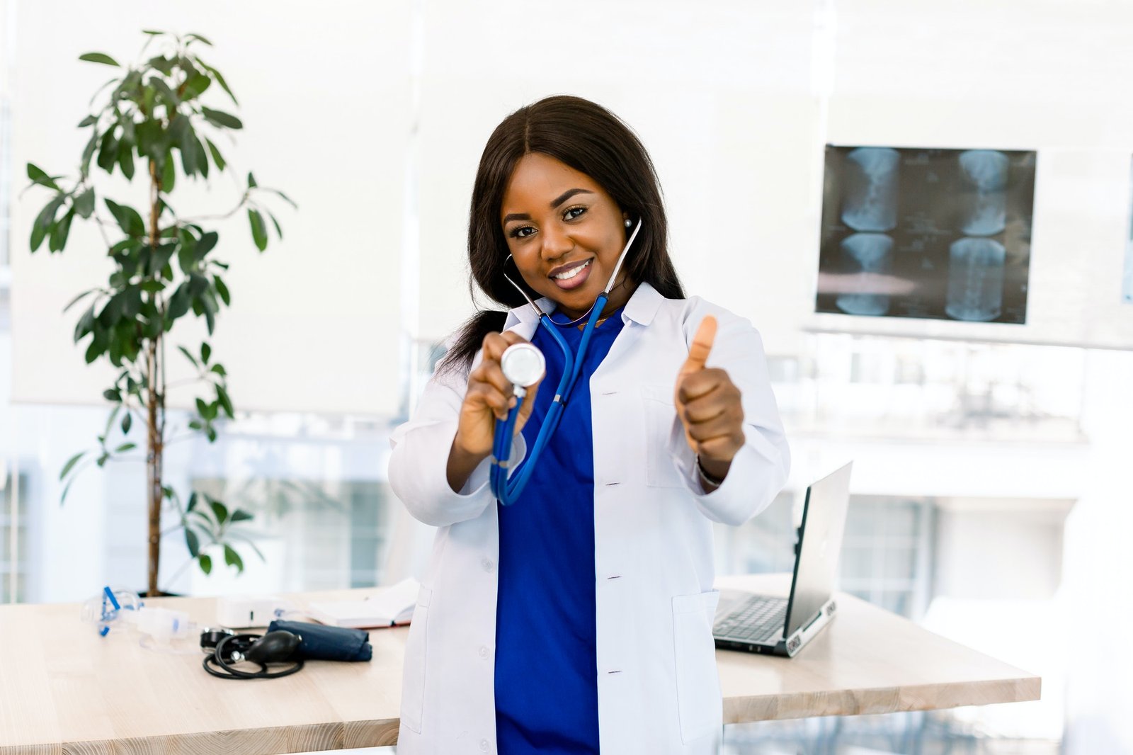 Closeup portrait of friendly, smiling confident African woman healthcare professional in lab coat